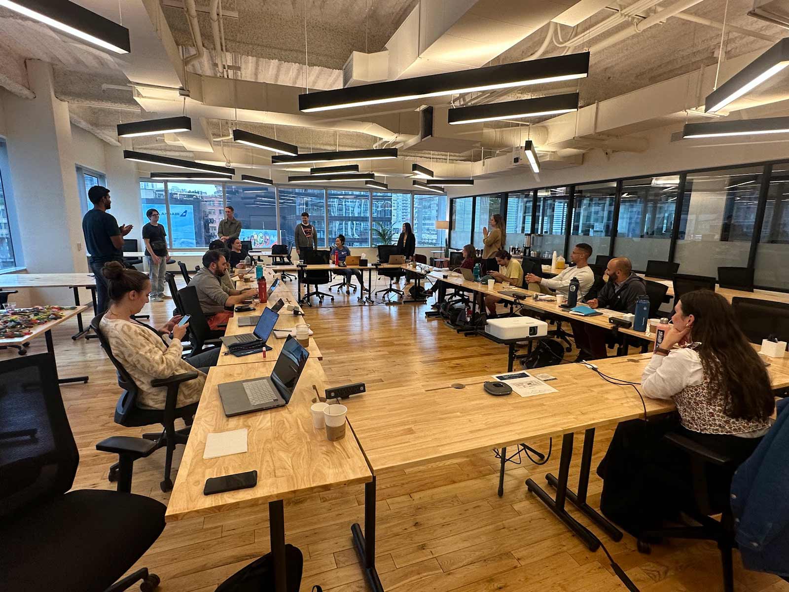 A group of people working on their computers during an in-person working session.